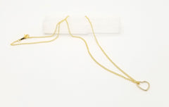 An 18-inch gold box chain necklace with a gold floating heart pendant and gold clasp